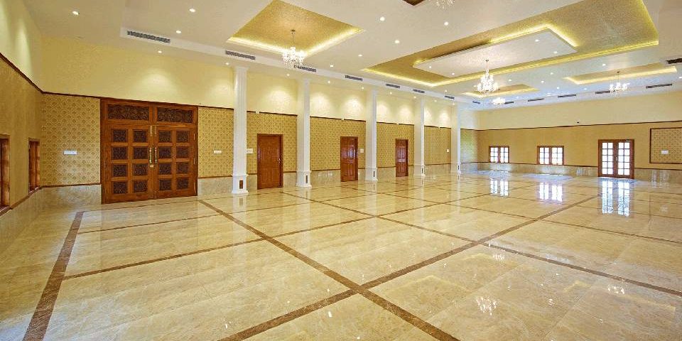 A spacious air conditioned wedding hall with great ambience with golden and white coloured ceiling.