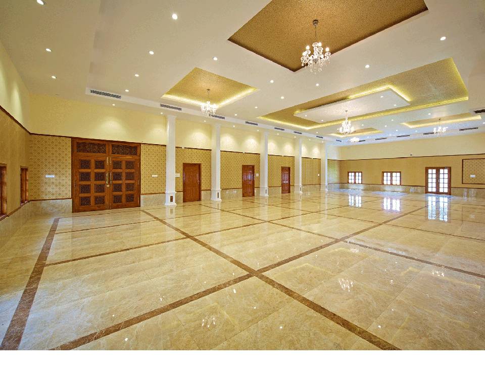 A spacious air conditioned wedding hall with great ambience with golden and white coloured ceiling.
